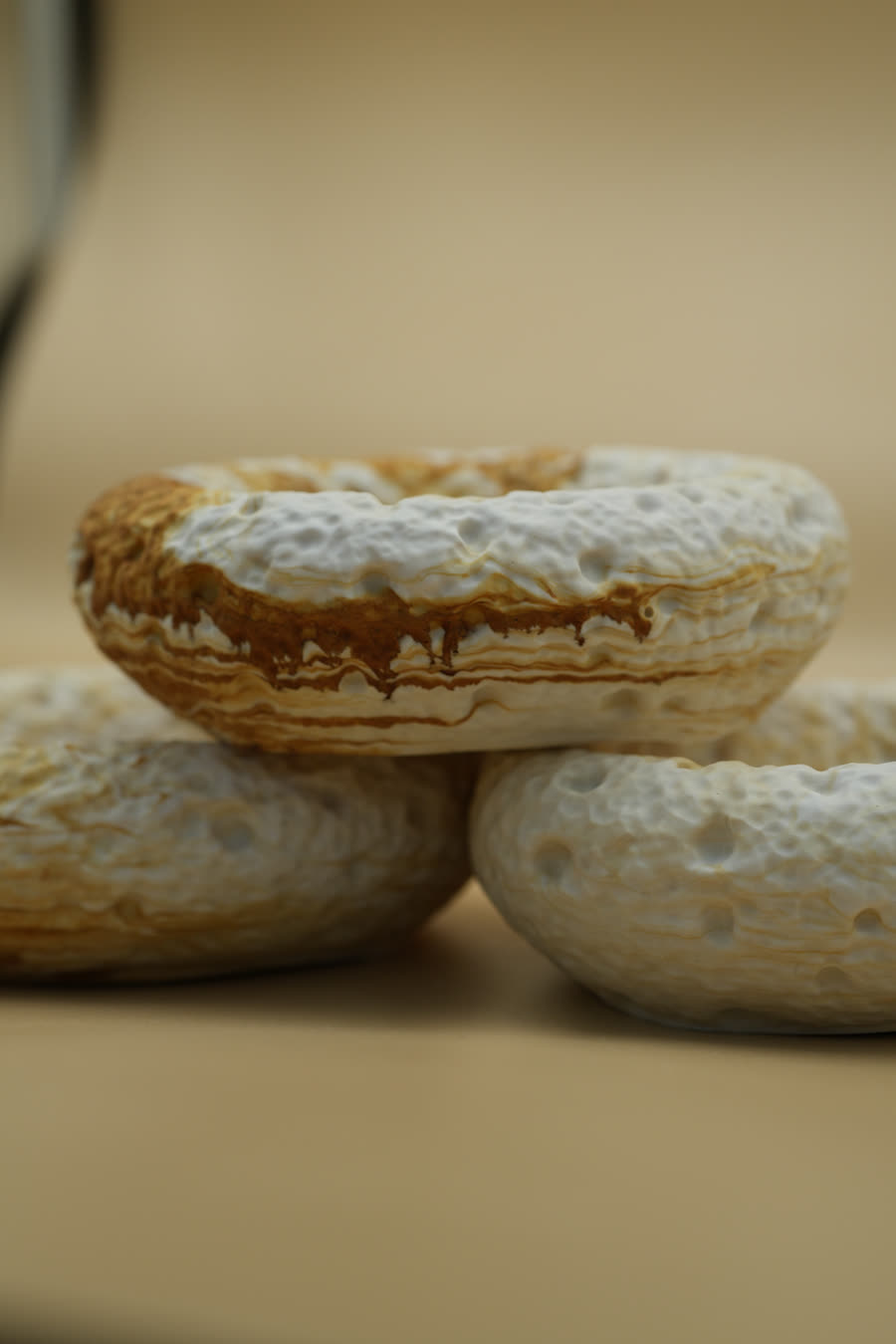 Round bowls with a cratered, pitted surface